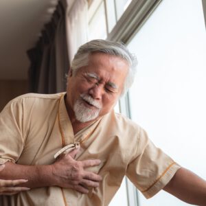 Man holding his chest with nurse